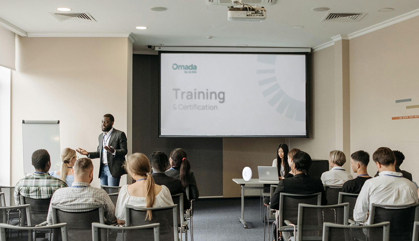 A classroom full of people preparing for an Omada training course