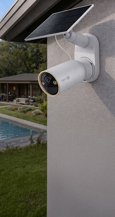 Tapo battery camera mounted outdoors with a solar panel